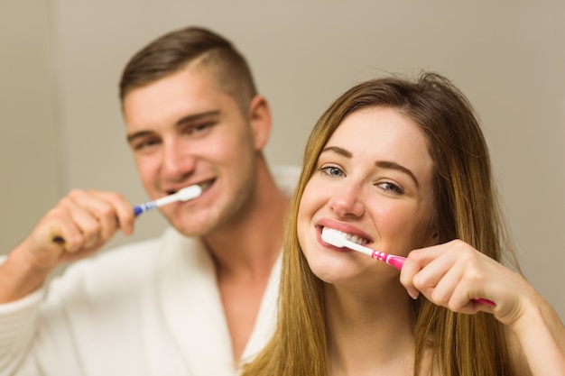  Cute couple brushing their teeth