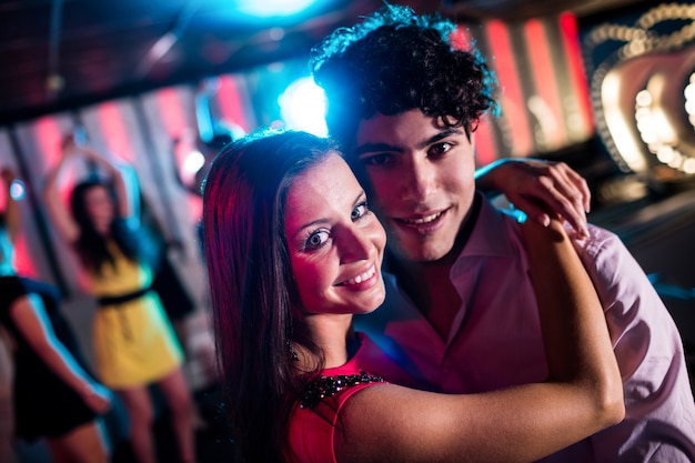 Cute couple dancing together on dance floor