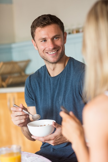 Cute couple having cereal for breakfast