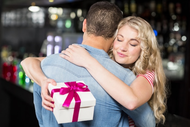 Cute couple hugging having a gift