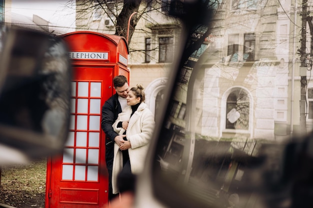 A cute couple in love in outerwear is walking on the street in spring Recreation together in the open air Young stylish couple