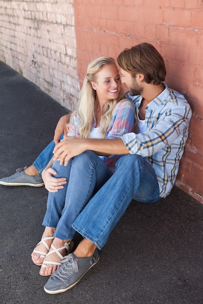 Cute couple sitting on ground