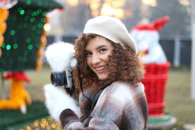 Cute curly hair girl taking photos with the camera