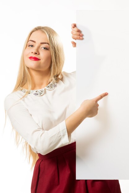 Cute cute girl smiling on a blank wall background Young woman in hand holds glasses Place for advertising copy space