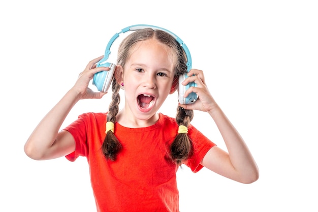 Cute european girl listening to music and shouting with wireless headphones isolated on white background