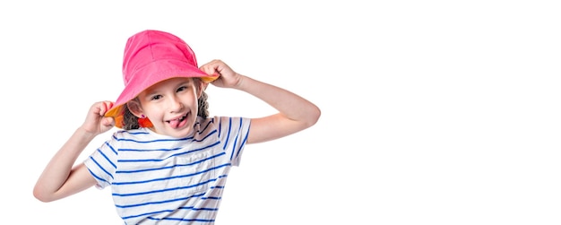 Cute european little girl with pink hat sticking tongue out isolated on white background Free space