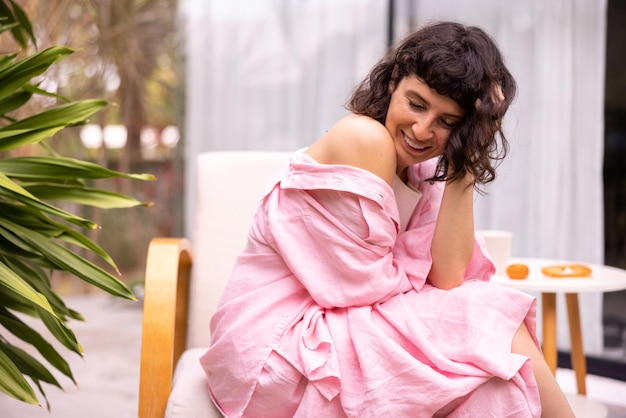 Cute fairskinned young brunette woman with closed eyes spends vacation in hotel backyard Relaxation concept