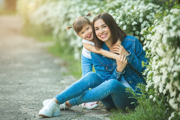 Cute family outdoors. Young pretty mother with her little daughter 