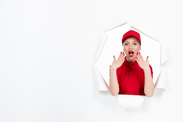 Cute female worker in red uniform on white