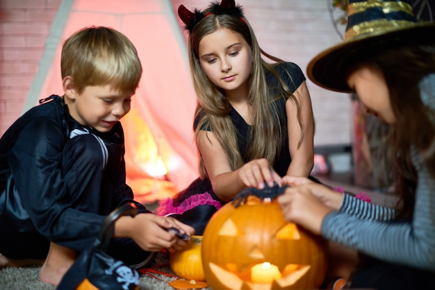 Cute friends playing with Halloween toys