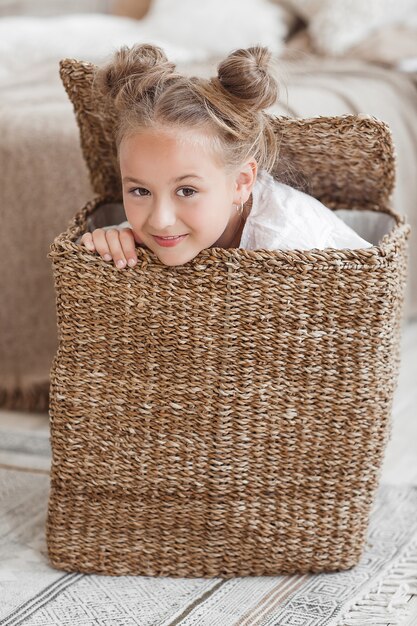 Cute funny little girl close up portrait in the basket