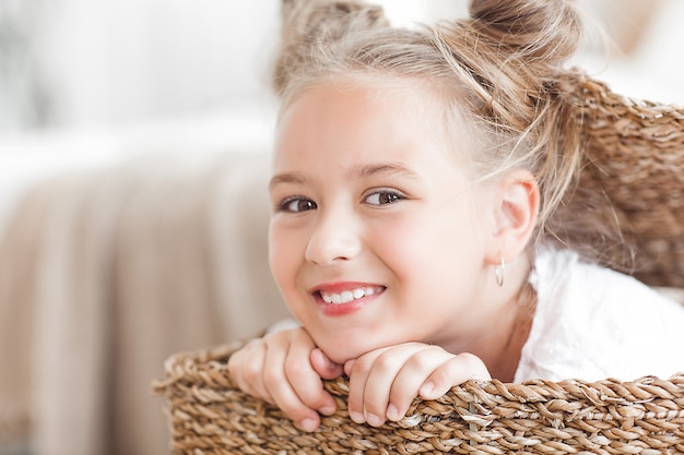 Cute funny little girl close up portrait in the basket