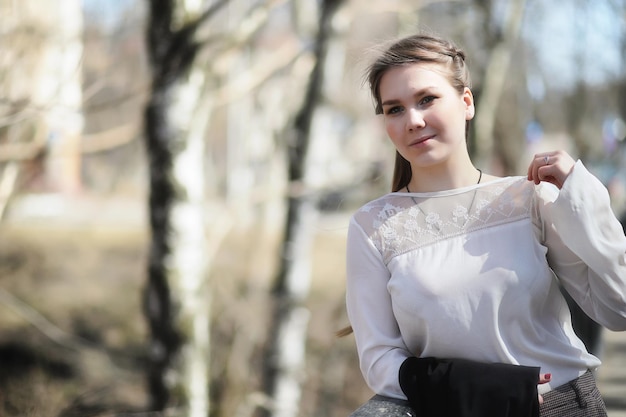 Cute girl in an autumn park in the afternoon