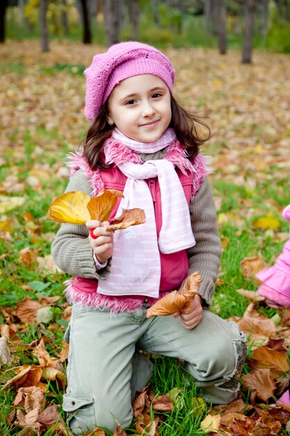 Cute girl in autumn park. Portrait shot.