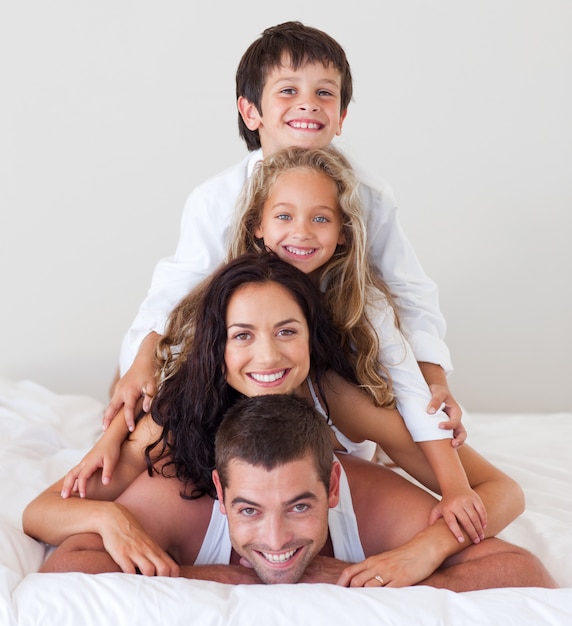 Cute girl and boy having fun with their parents