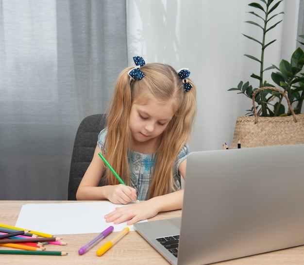 Cute girl doing homework in her room at home