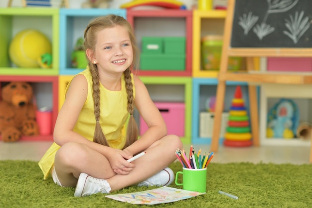 Cute girl drawing at home