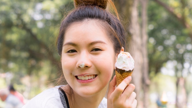 cute girl eat ice cream in close up face feeling delicious