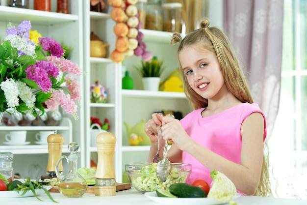 Cute girl eating delicious fresh salad