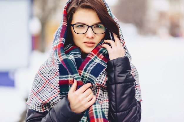 Cute girl in glasses and a scarf