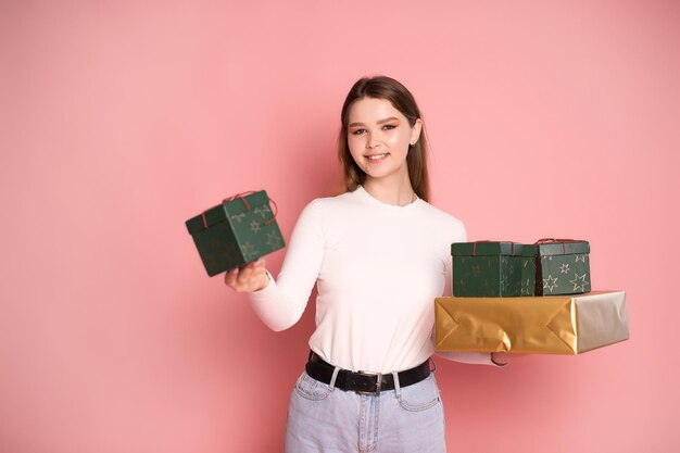 Cute girl holding gift boxes and laughing