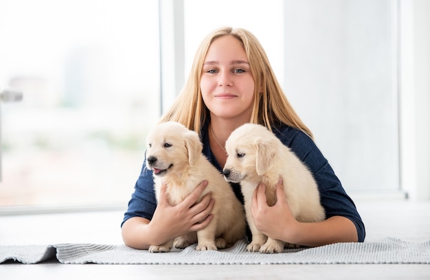 Cute girl hugging lovely puppies