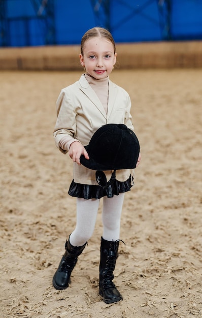 Cute girl in jockey wearing Young pretty child with horse helmet