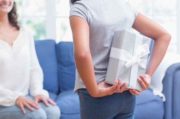 Cute girl offering gift to her mother 