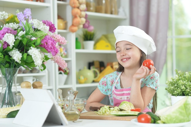 Cute girl preparing delicious fresh salad