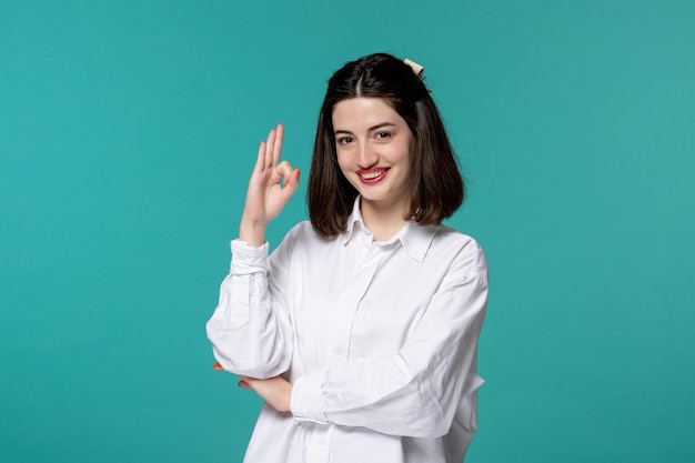 Cute girl pretty brunette young sweet girl in white shirt showing ok gesture