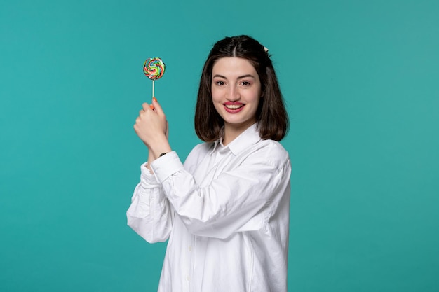 Cute girl pretty brunette young sweet girl in white shirt super cheerful for a lollipop