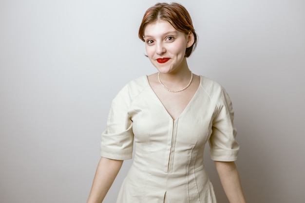 Cute girl smiling on a light background