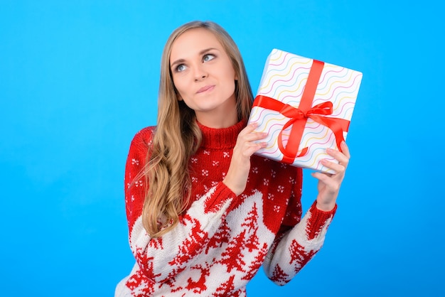 Cute girl wants to open a giftbox