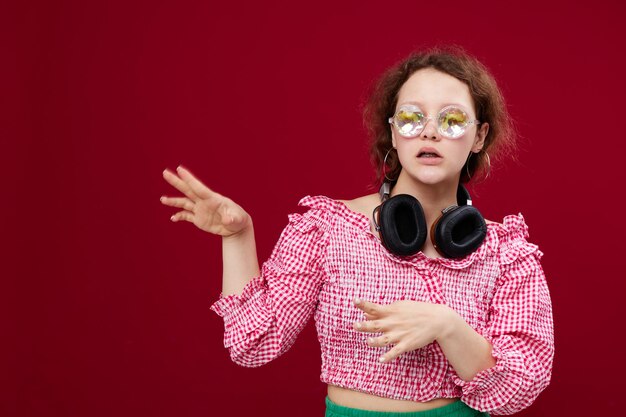 Cute girl with headphones glasses with diamond red background unaltered