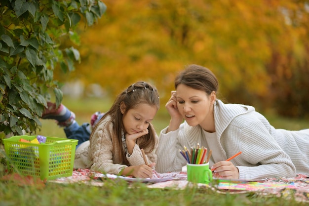 Cute girl with her mother doing homework