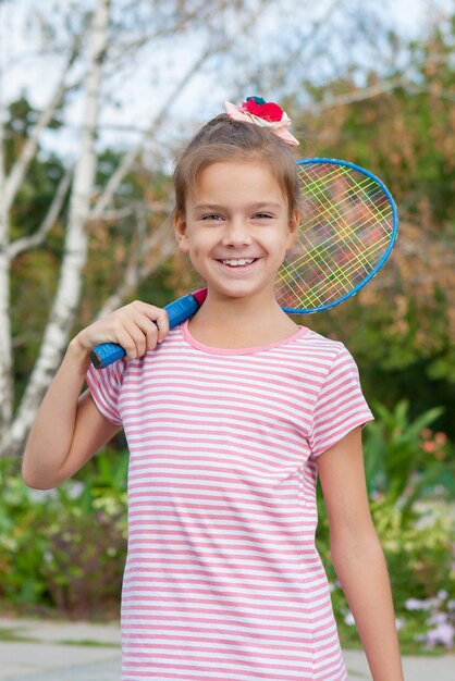 Cute girl with racket Outdoors