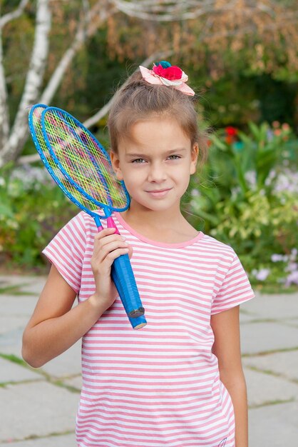 Cute girl with racket Outdoors