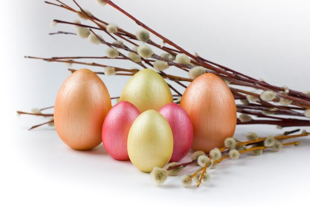 Cute golden Easter eggs and pussy willow isolated on white background