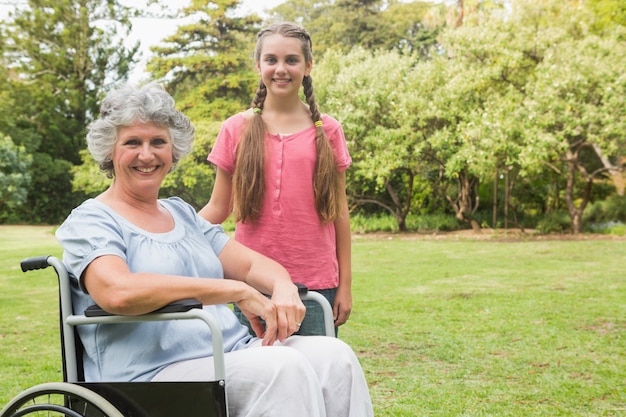 Cute granddaughter with grandmother in her wheelchair 