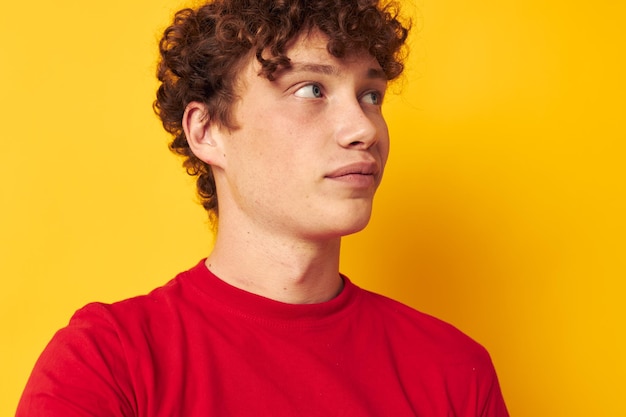 Cute guy with curly hair in a red tshirt closeup