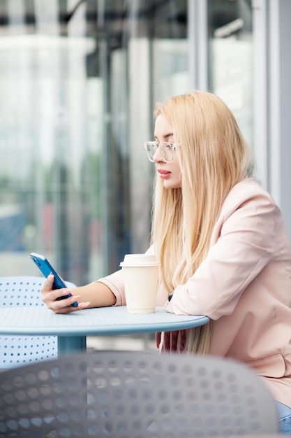 Cute happy beautiful young woman makes selfie on a smartphone.