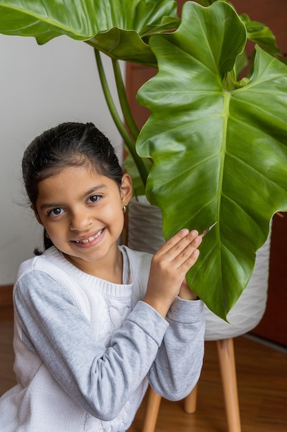 Cute happy girl because she enjoys the plants