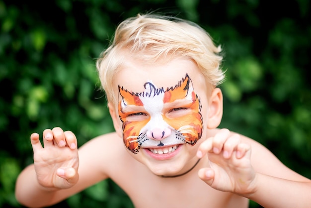 Cute happy little boy with his face painted