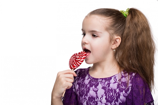 Cute happy little girl with lollipop caucasian on isolated white background