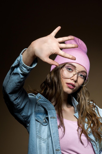 Cute hipster girl showing stop sign