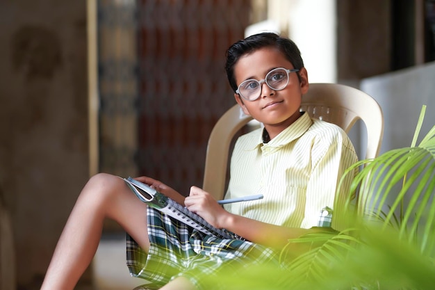 Cute indian child studying at home