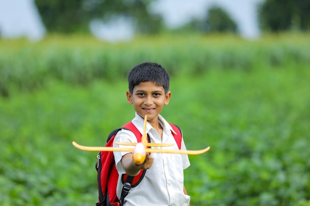 Cute Indian kid playing with a toy plane