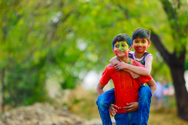 Cute indian little children playing holi. Holi is colors festival in india