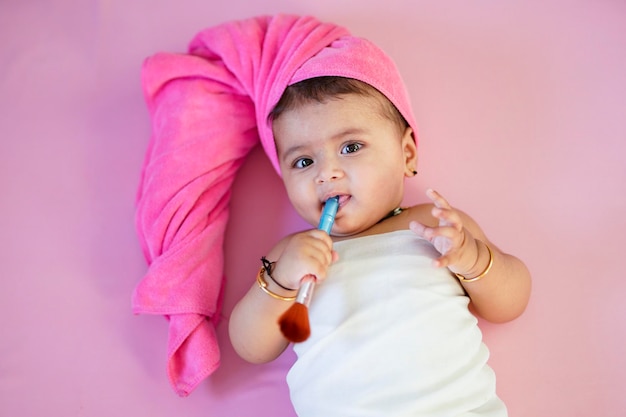 Cute indian little girl child doing make up