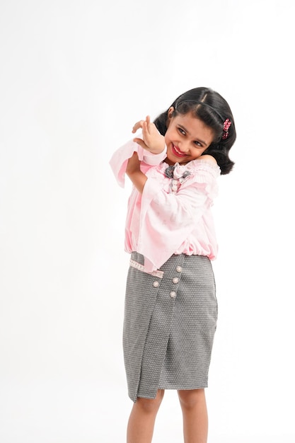 Cute indian little girl giving expression on white background